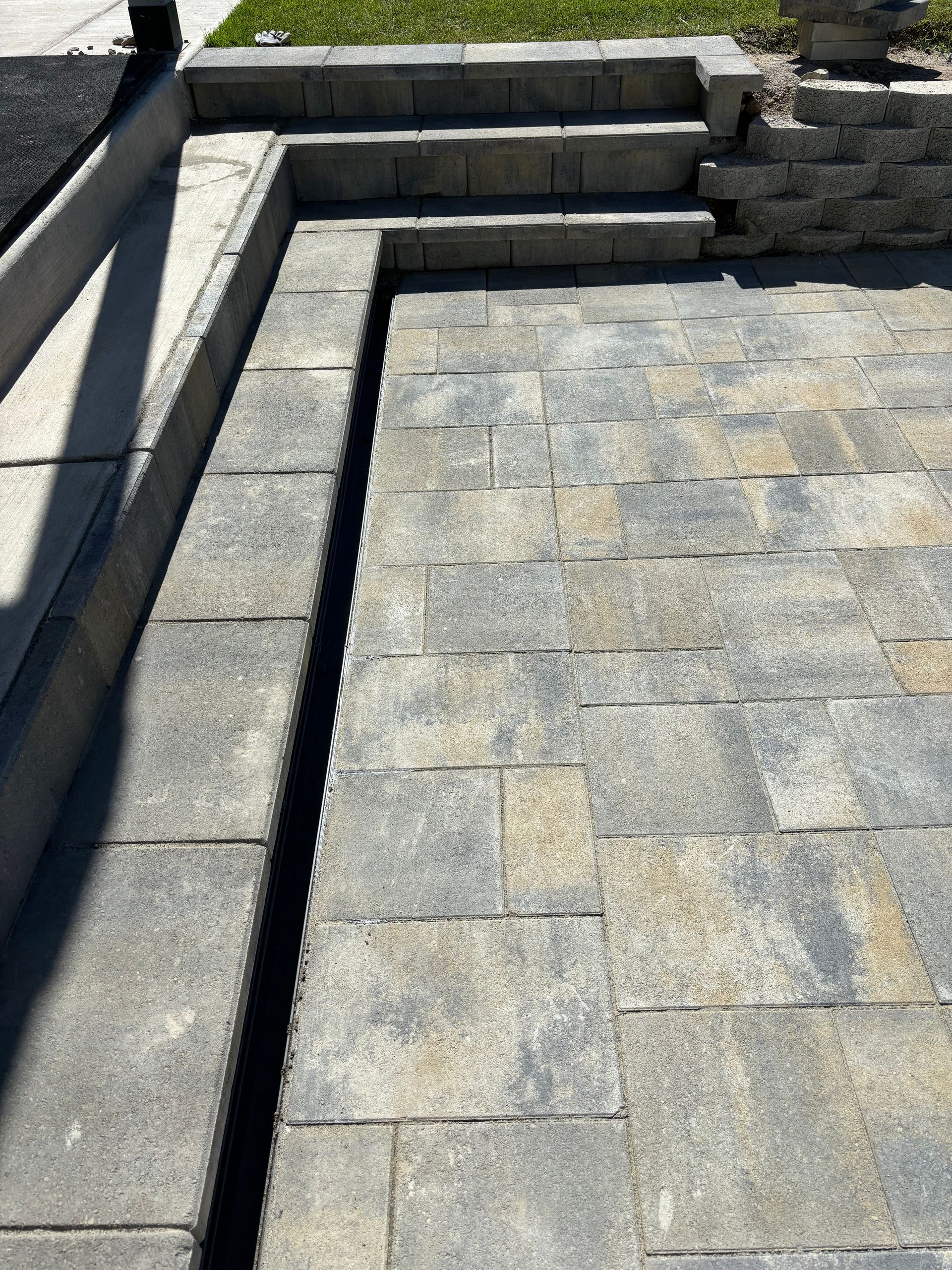 Judd Landscape & Curbing LLC | a brick walkway with stairs leading up to it.