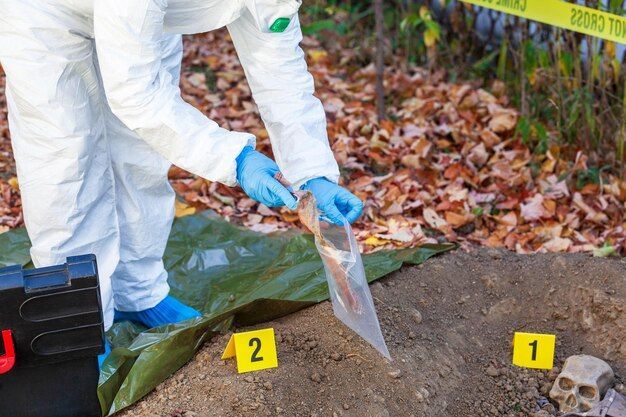 A forensic scientist is taking a sample from a crime scene.