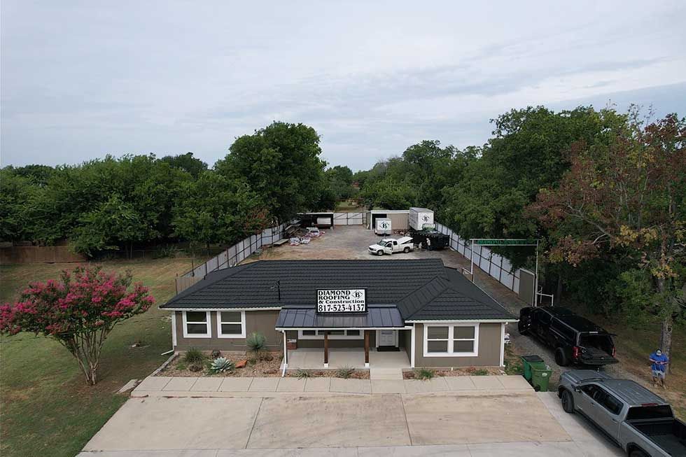 An aerial view of a house with a lot of cars parked in front of it.