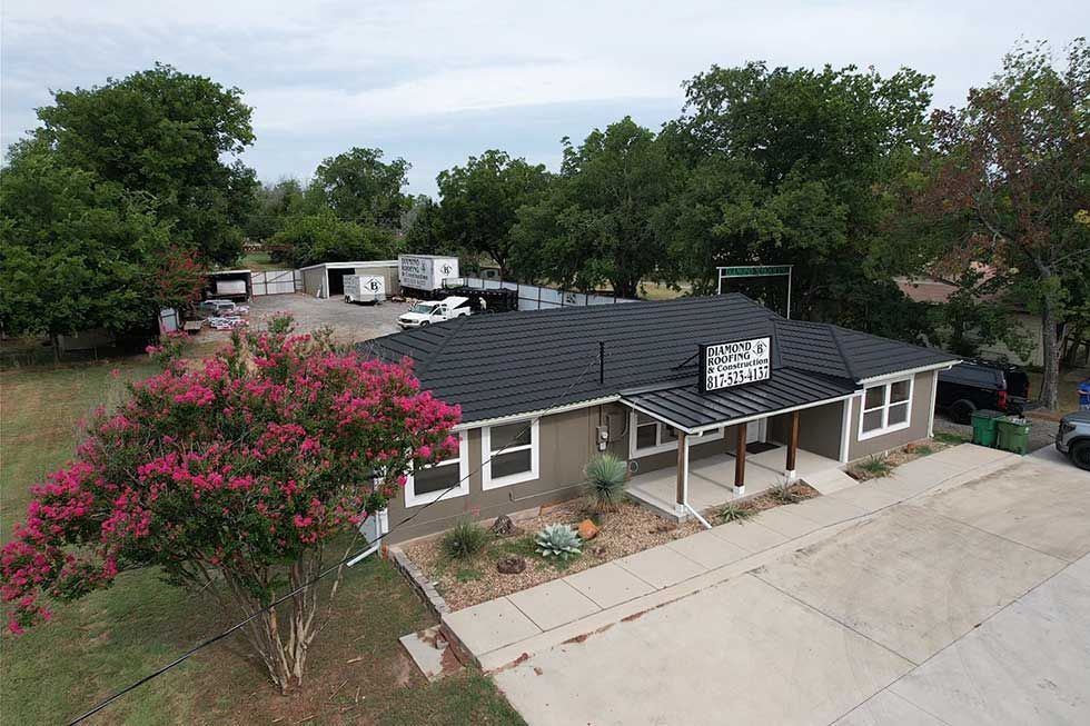 An aerial view of a large house with a pool in the backyard.