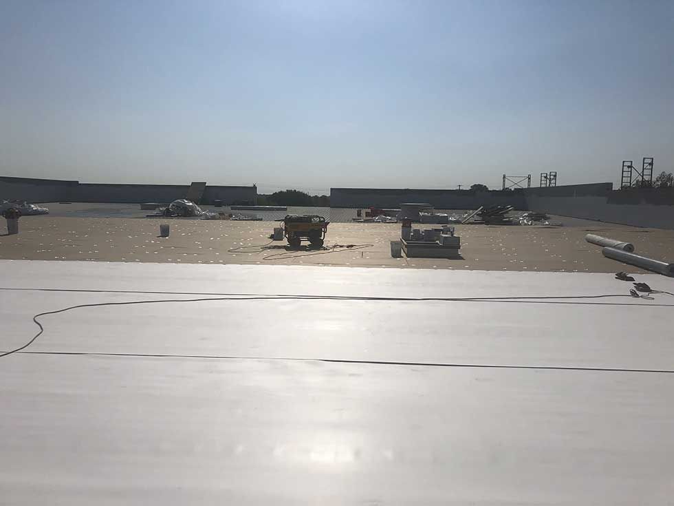 A white roof is being installed on top of a building.