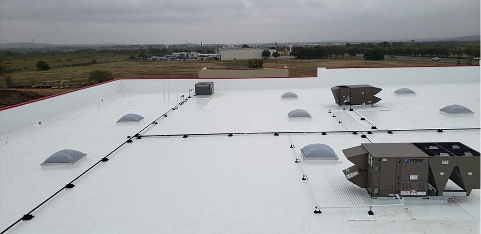 A large white roof with a lot of skylights on it.