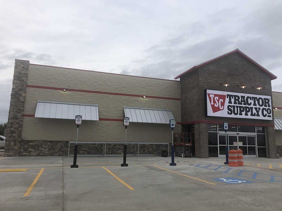 A large tractor supply store with a parking lot in front of it.