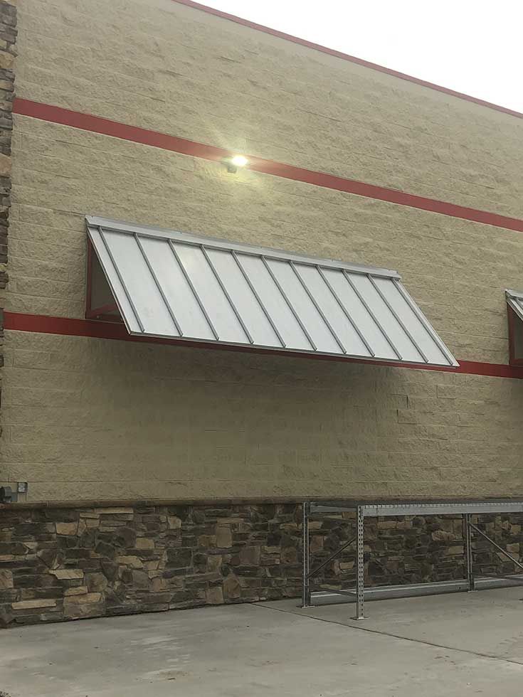 A building with a white awning on the side of it.