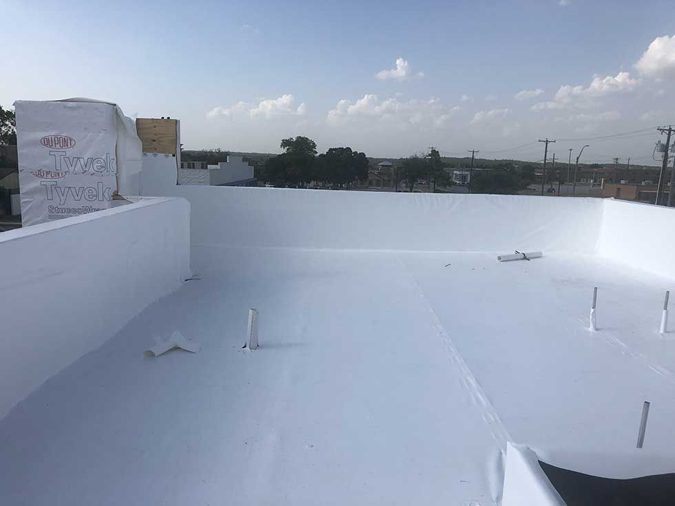A white roof with a blue sky in the background.