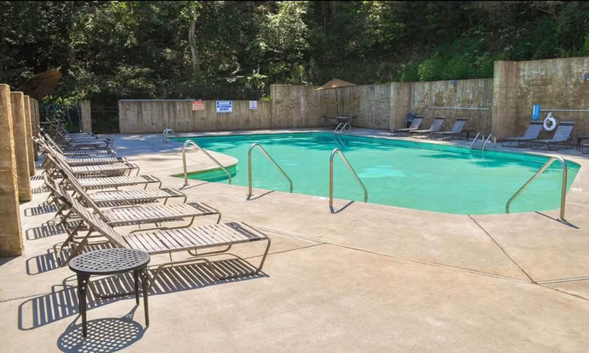 Outdoor swimming pool with lounge chairs.