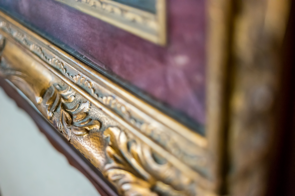 A close up of a picture frame on a wall.