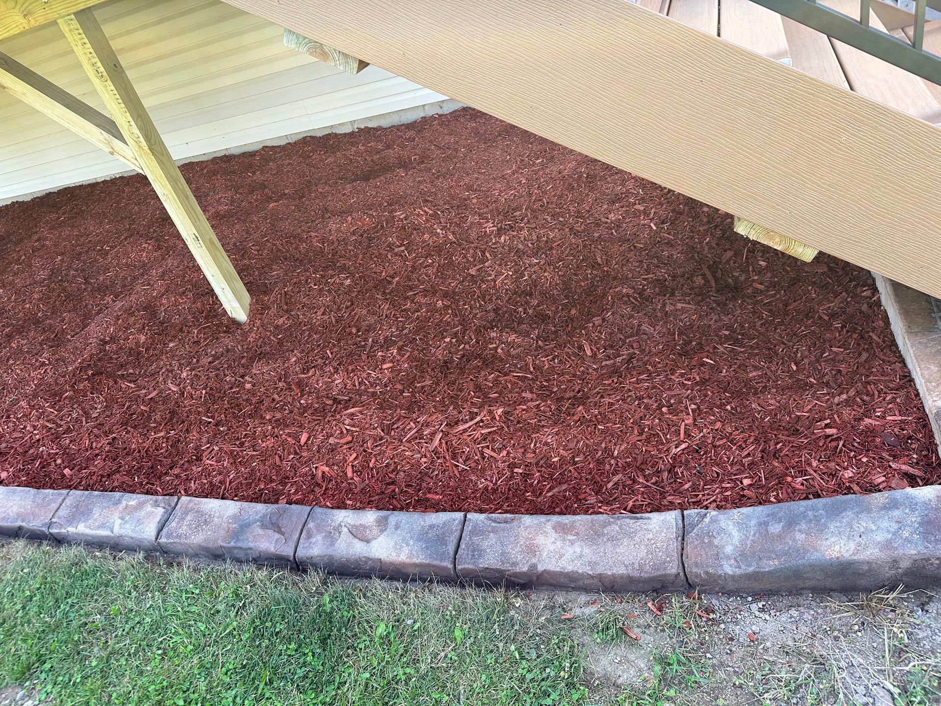 Three copper pipes are connected to each other on a wall.