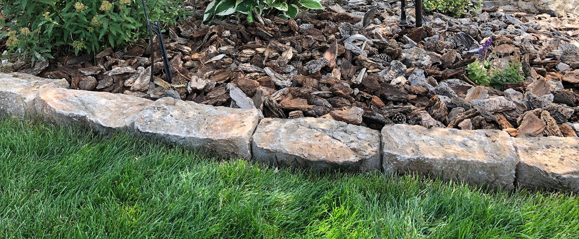 Three copper pipes are connected to each other on a wall.