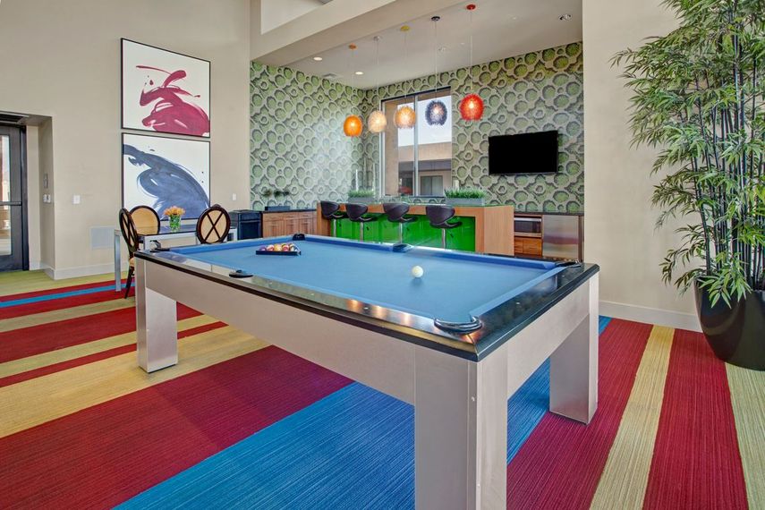 There is a pool table in the middle of the room.