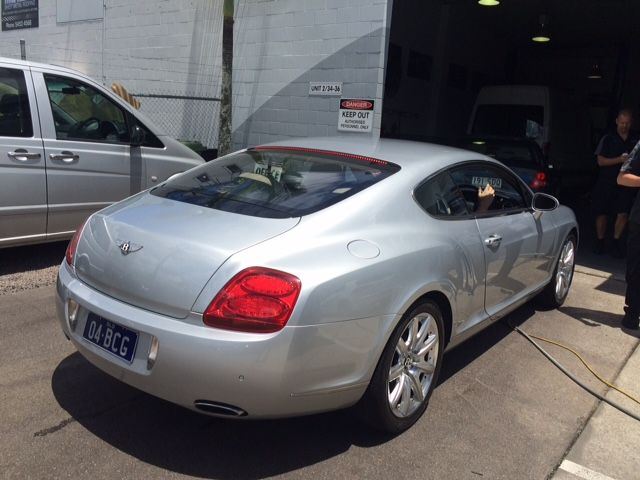 A Silver Bentley Is Parked in Front of A Garage — SVS Autocare in Kunda Park, QLD