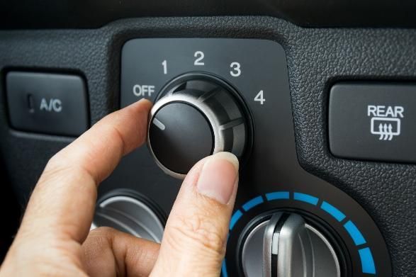 A Person Is Adjusting the Air Conditioning in A Car — SVS Autocare in Kunda Park, QLD