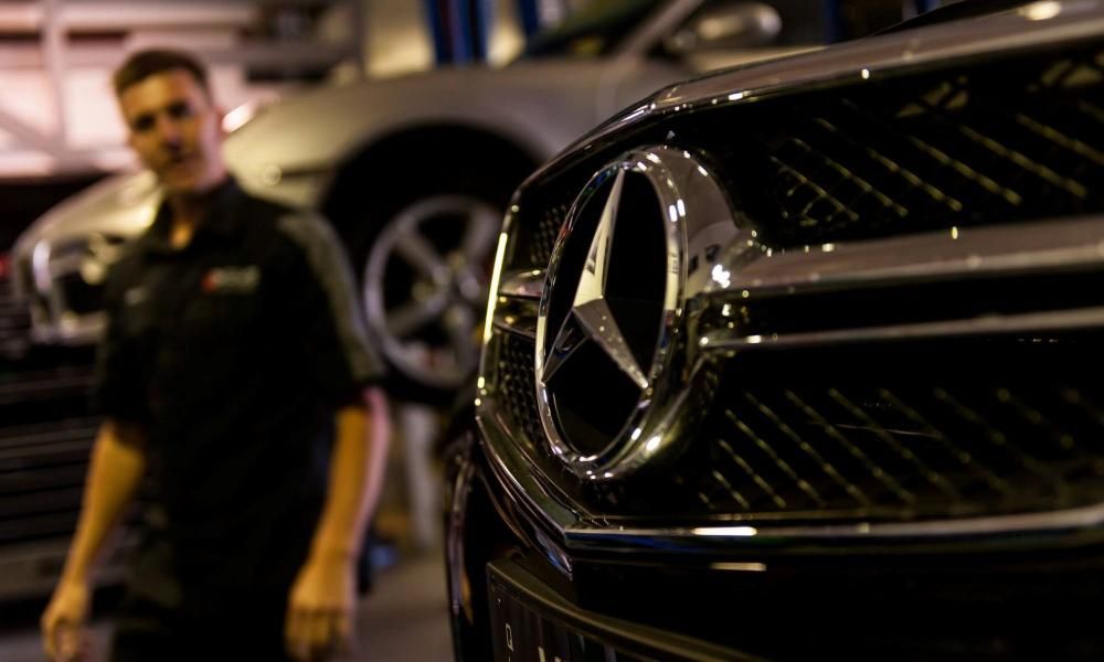 A Man Is Standing in Front of A Mercedes Car in A Garage — SVS Autocare in Kunda Park, QLD