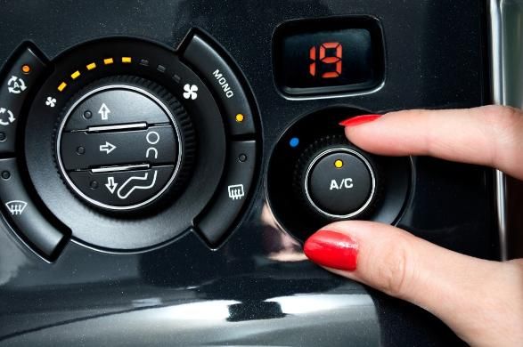 A Woman with Red Nails Is Adjusting the A/c in A Car — SVS Autocare in Kunda Park, QLD