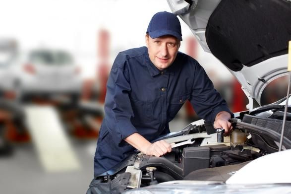 A Man Is Working Under the Hood of A Car — SVS Autocare in Kunda Park, QLD