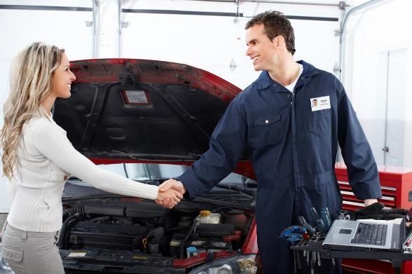 A Woman Is Shaking Hands with A Mechanic in Front of A Car — SVS Autocare in Kunda Park, QLD