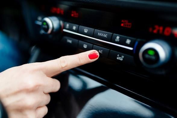 A Woman with Red Nails Is Pressing a Button on The Dashboard of A Car — SVS Autocare in Kunda Park, QLD