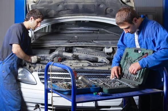 Two Mechanics Are Working on A Car in A Garage — SVS Autocare in Kunda Park, QLD