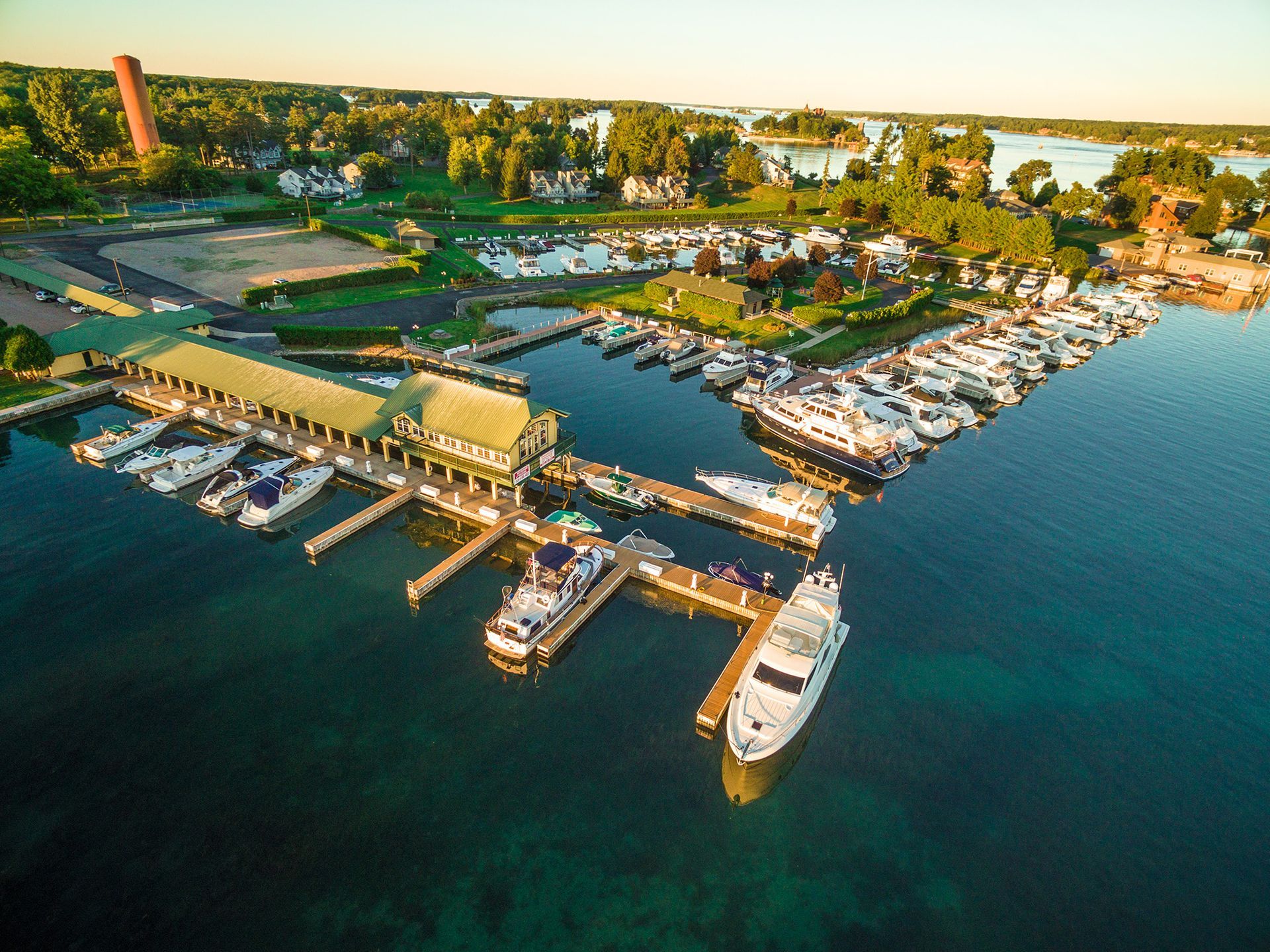 An aerial view of a marina with boats docked in the water.