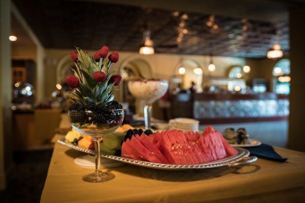 A plate of watermelon and berries on a table in a restaurant.
