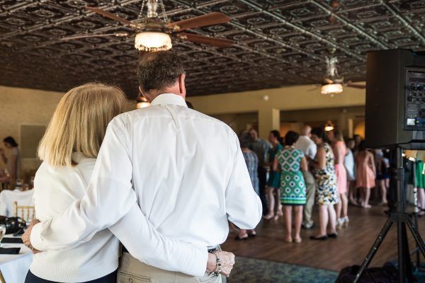 A man and a woman are standing next to each other on a dance floor.
