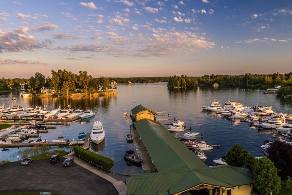 An aerial view of a marina filled with boats at sunset.