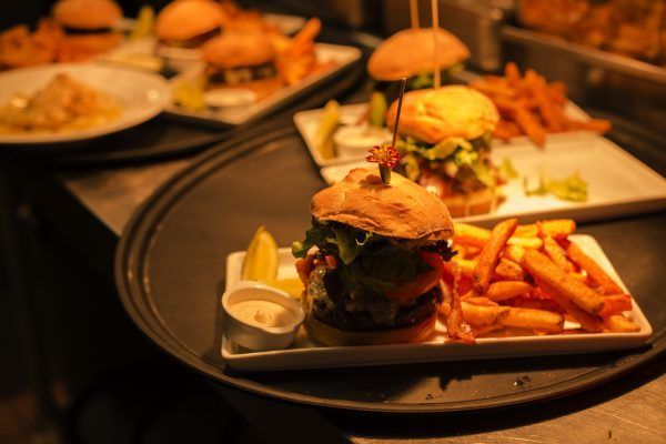 A tray of hamburgers and french fries on a table.