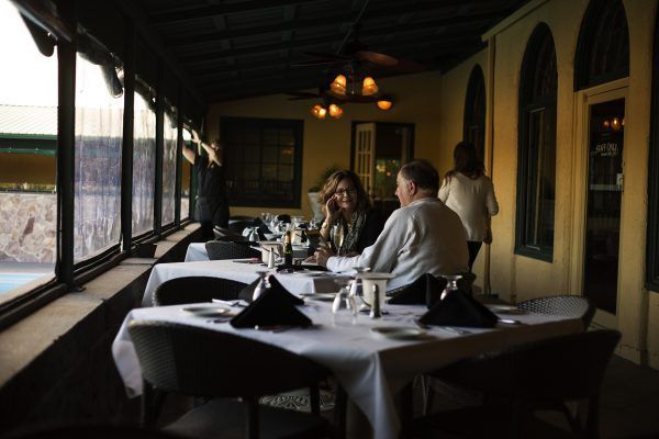 A group of people are sitting at tables in a restaurant