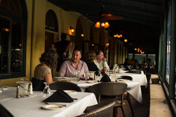 A group of people are sitting at tables in a restaurant.