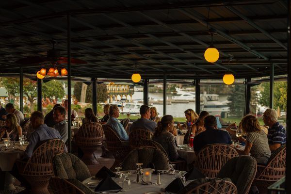 A group of people are sitting at tables in a restaurant.