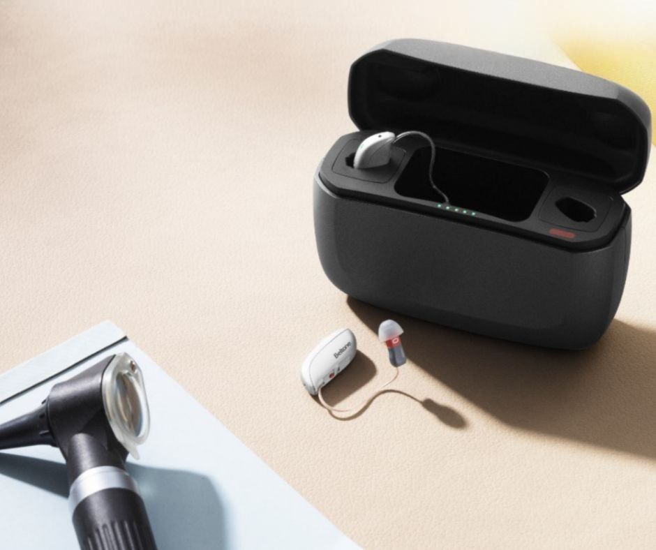 Torta mousse a tre strati con strati bianchi, al cioccolato e marroni, guarnita con more, su un'alzata in legno.