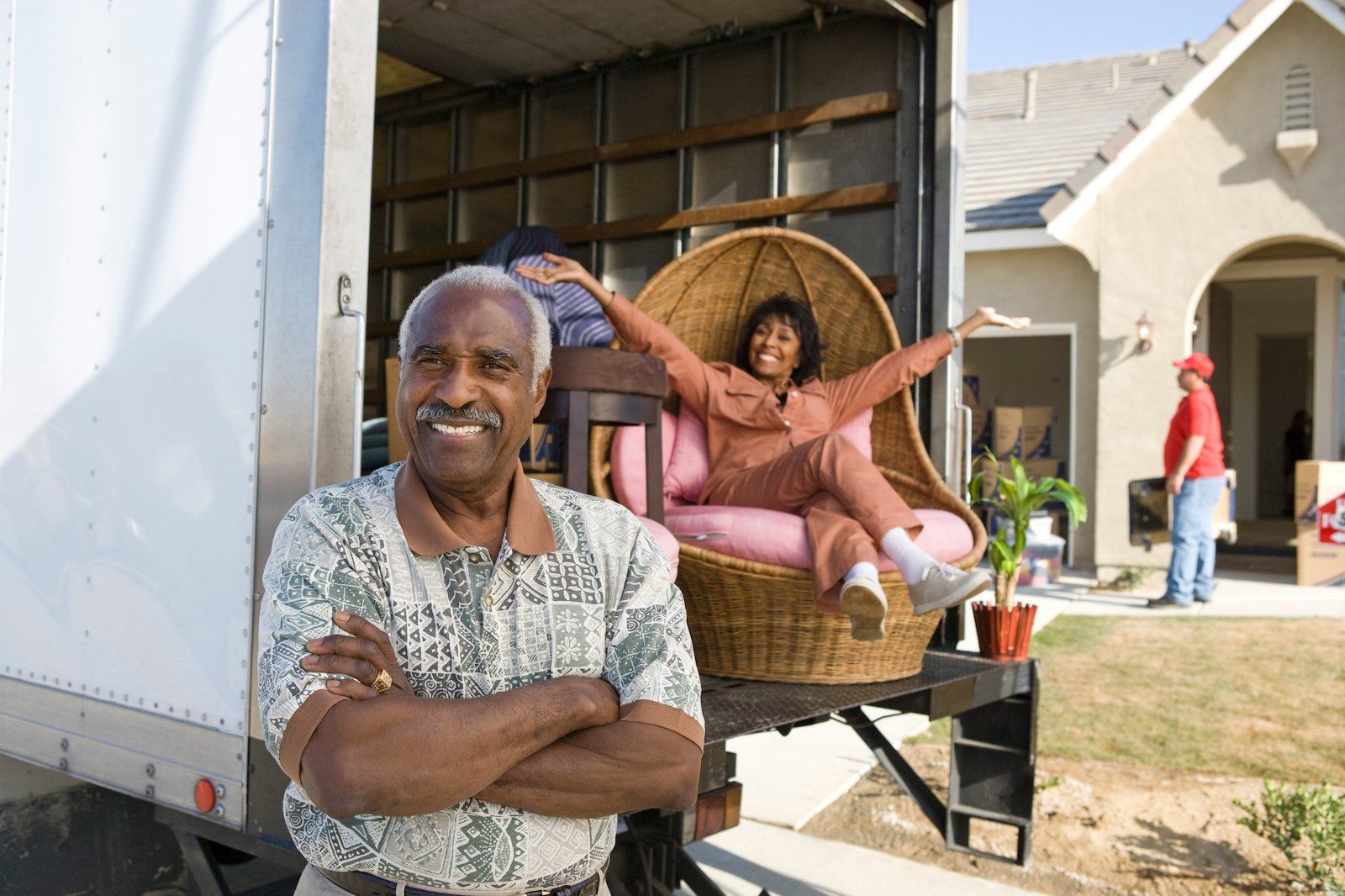 Joyful African American couple excitedly unpacking boxes and settling into their new home.