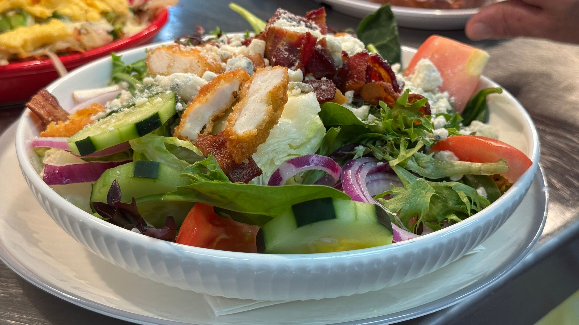 A close up of a salad in a bowl on a table.