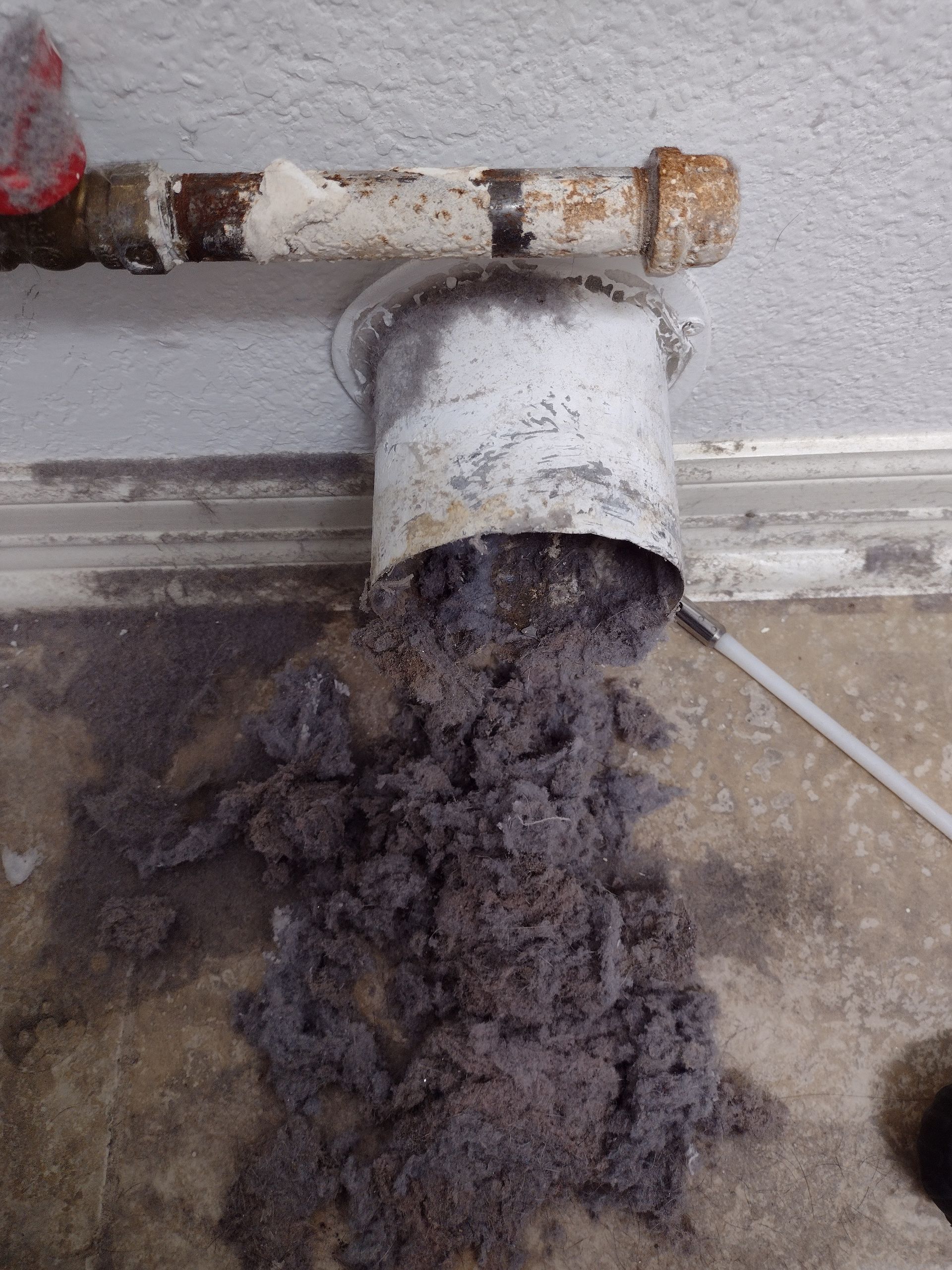 A pipe with a lot of dust coming out of it