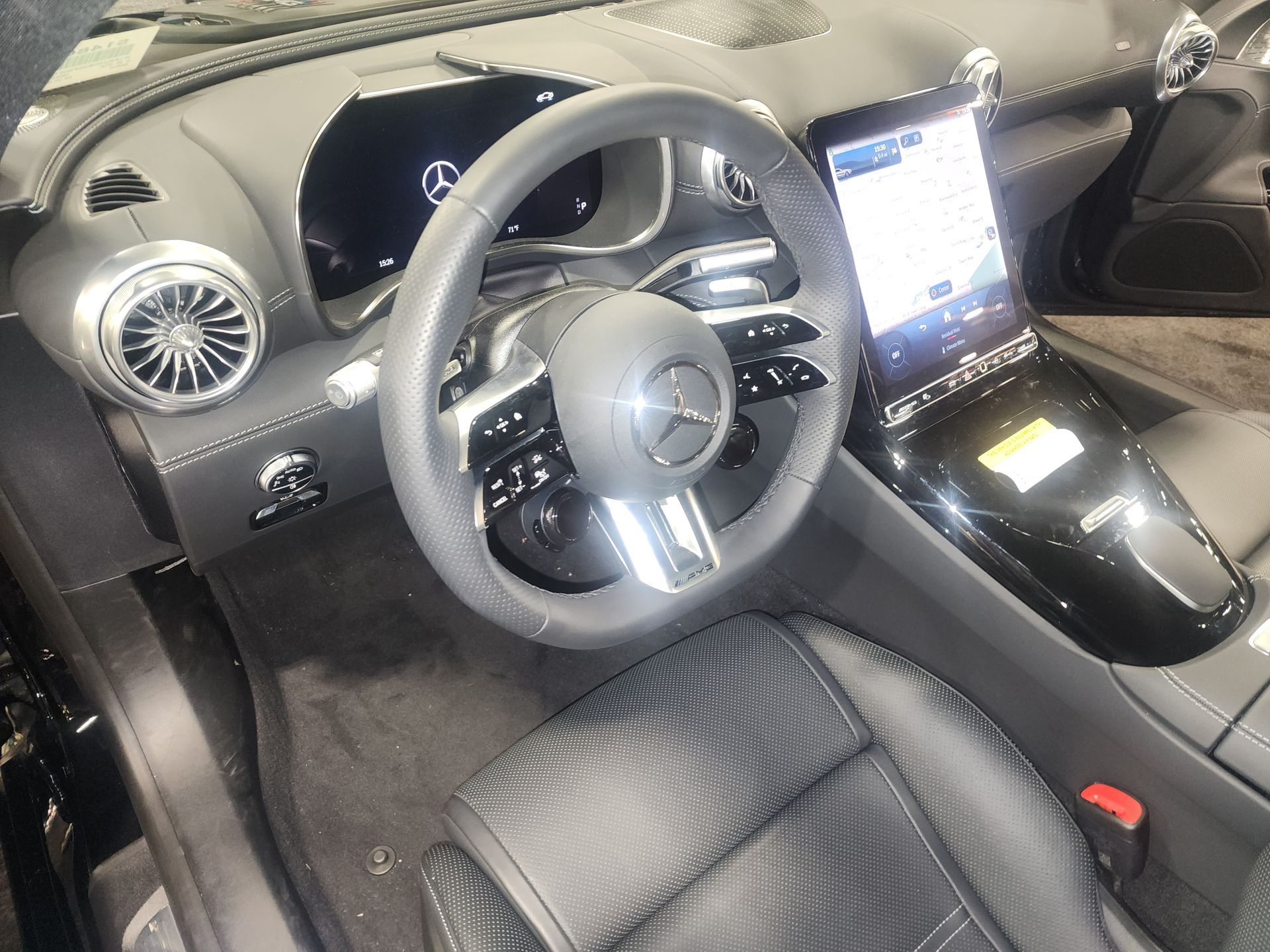 Cars parked in a line on an asphalt surface, various colors and models visible.