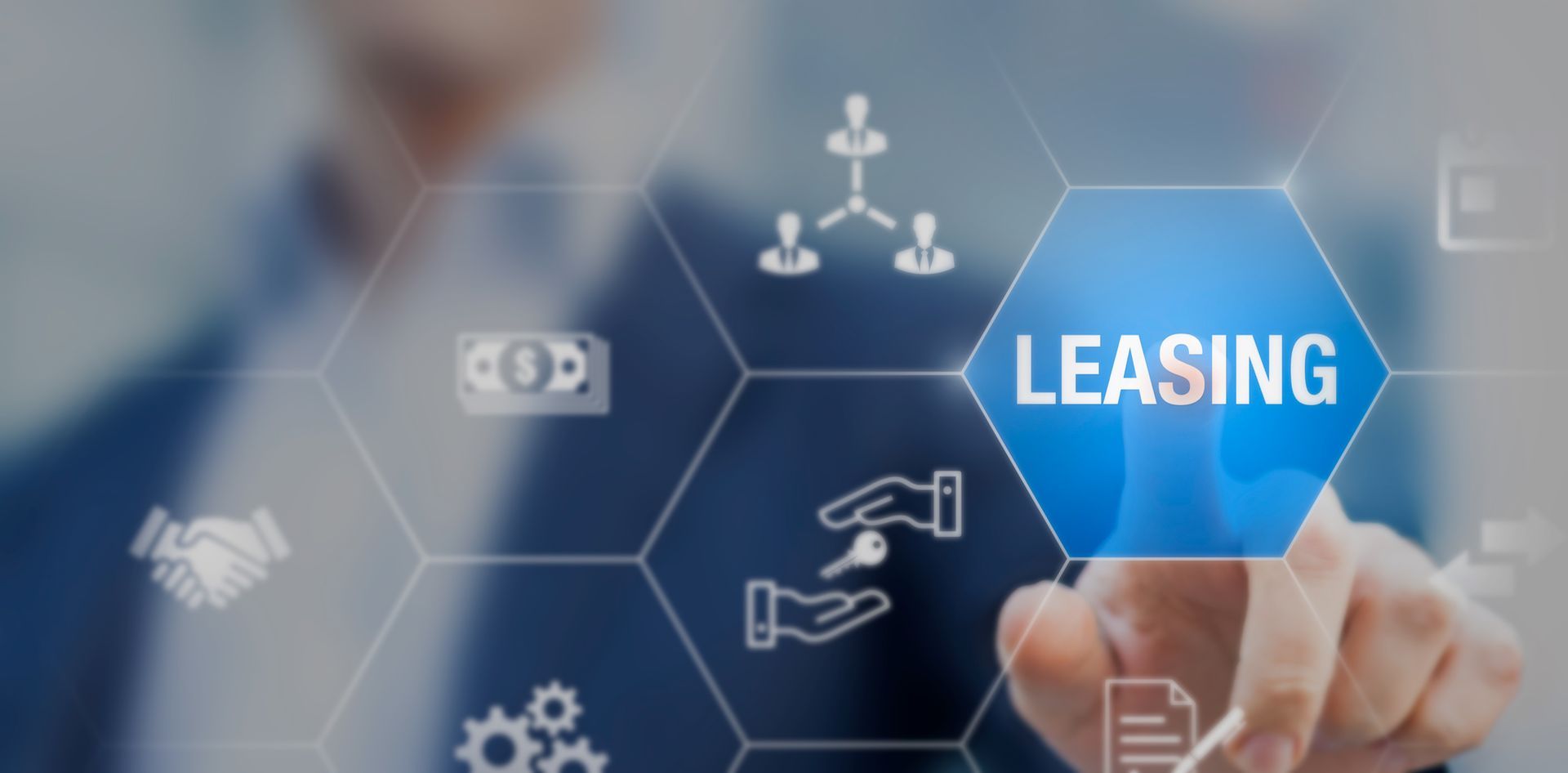 A man is pressing a blue button with the word leasing on it.