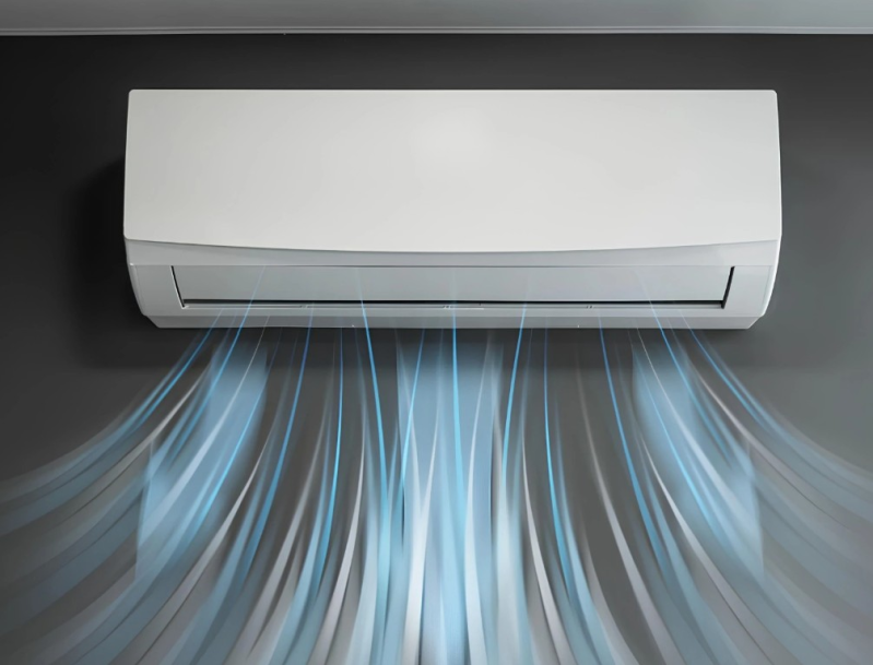 Un condizionatore bianco soffia aria fresca contro una parete grigio scuro.