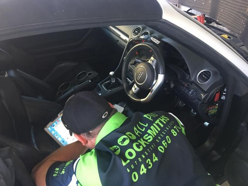 Person Working on the Dashboard of a White Car — All Pro Locksmiths In Port Macquarie, NSW