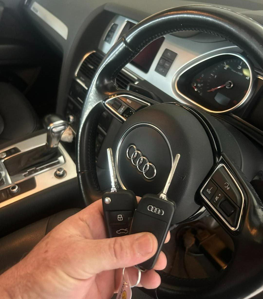Hand Holding Two Audi Car Keys — All Pro Locksmiths In Port Macquarie, NSW