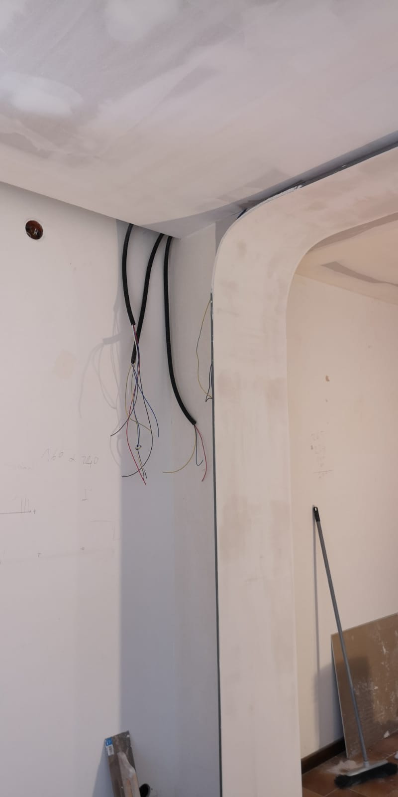 Un muro bianco con fili neri appesi