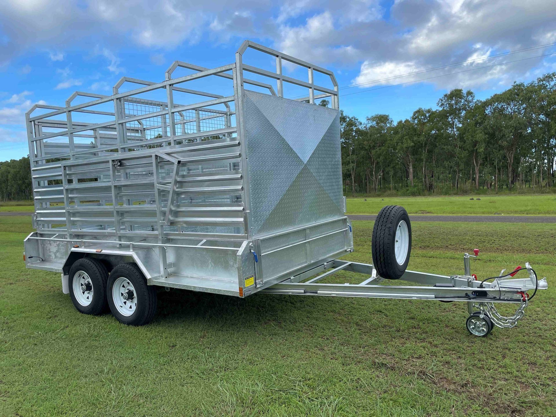 A trailer is parked in a grassy field.