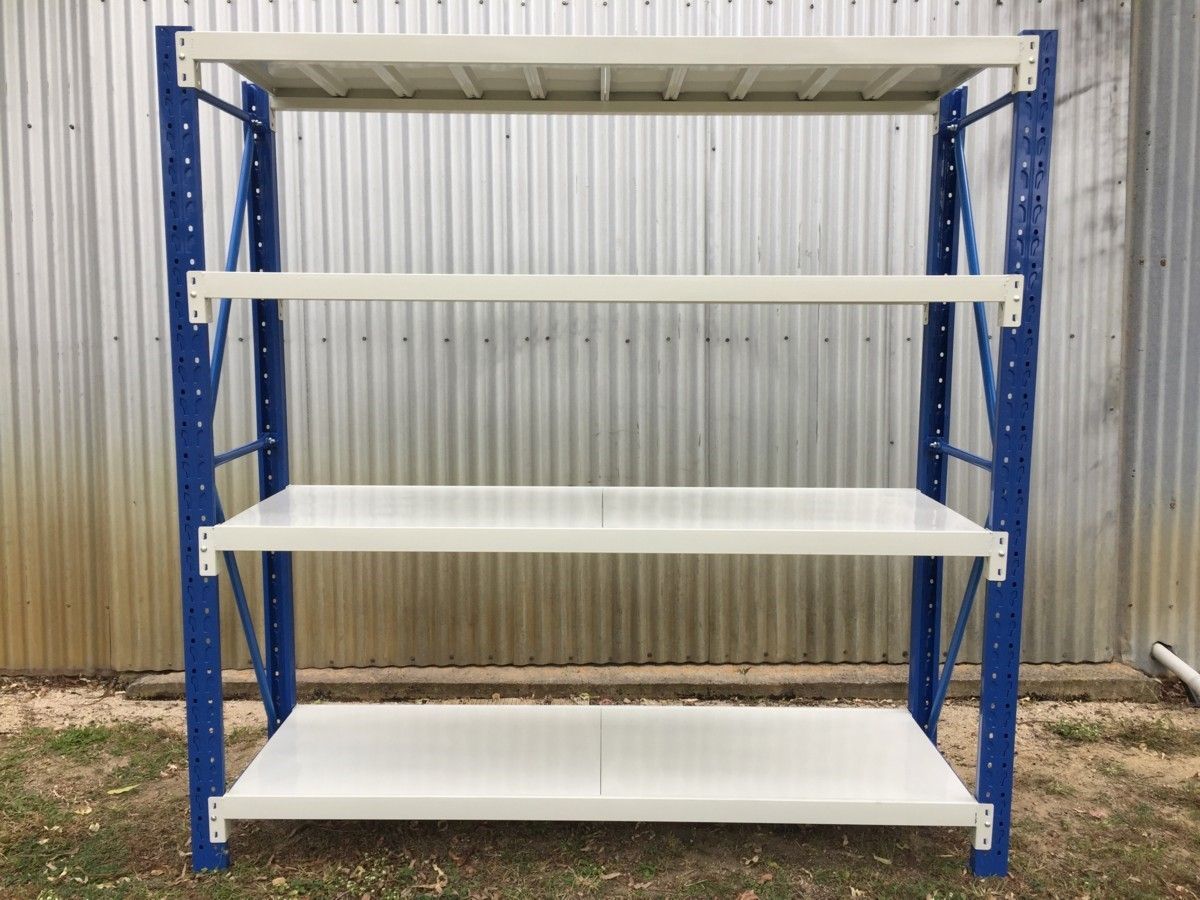 A blue and white shelving unit is sitting in front of a metal wall.