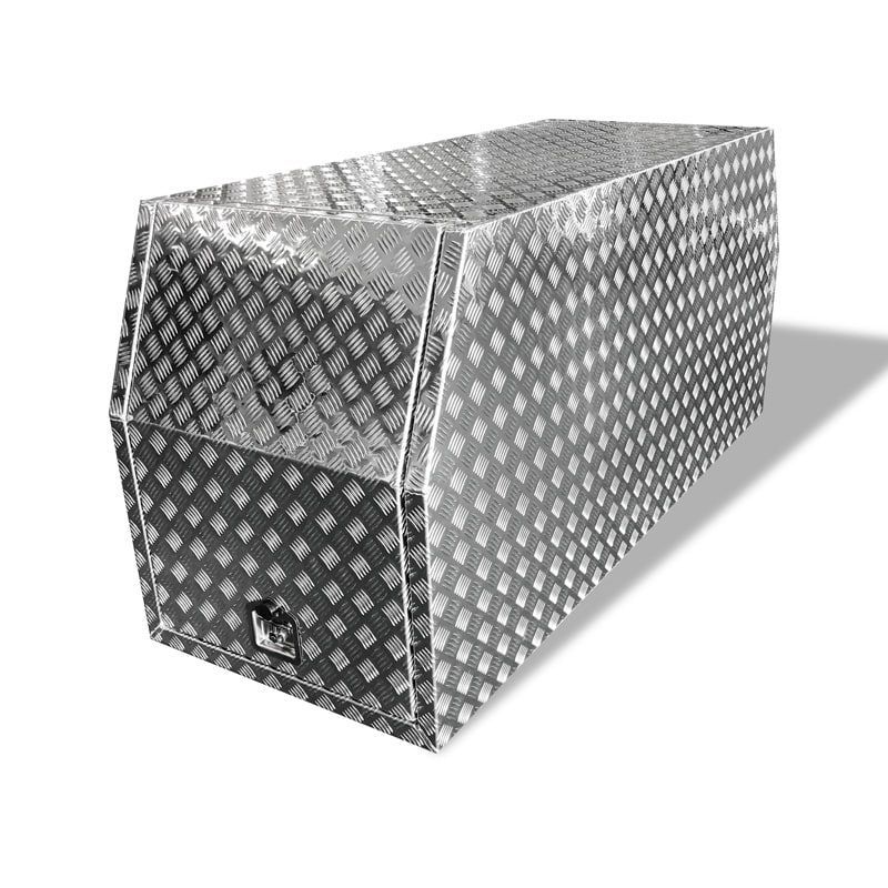 A silver box with a diamond pattern on it is sitting on a white surface.