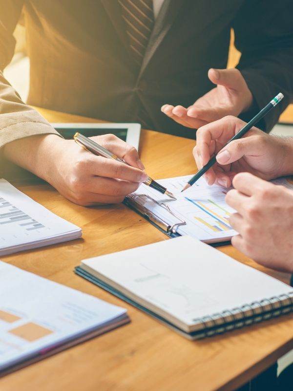 A business consultants disscuses a report at Hage & Hage LLC.