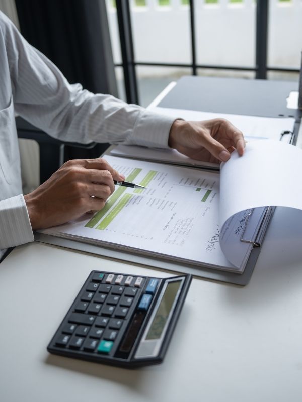 A business consultant is looking at a finance report at Hage & Hage LLC.