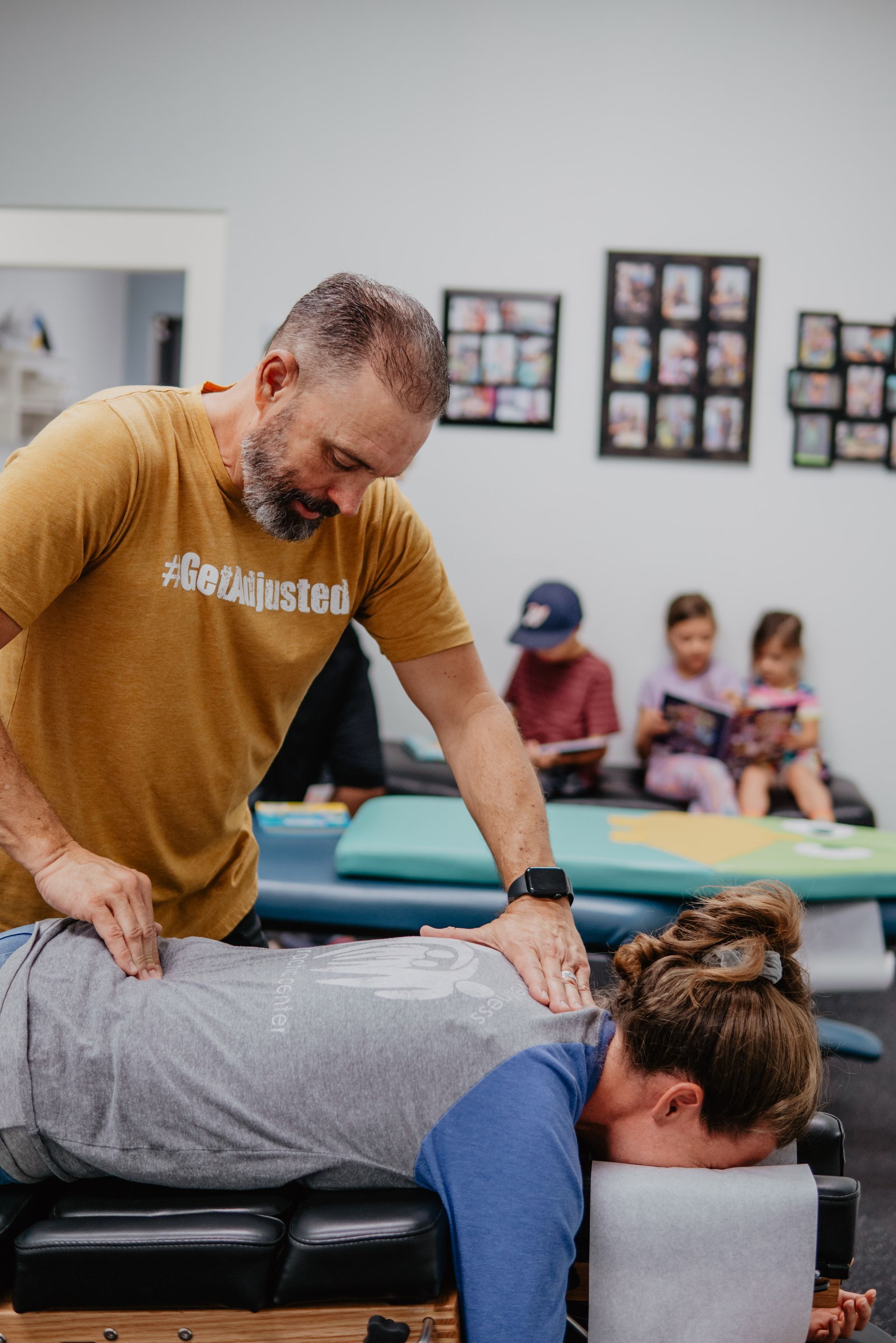 A man is giving a child a massage on a table.