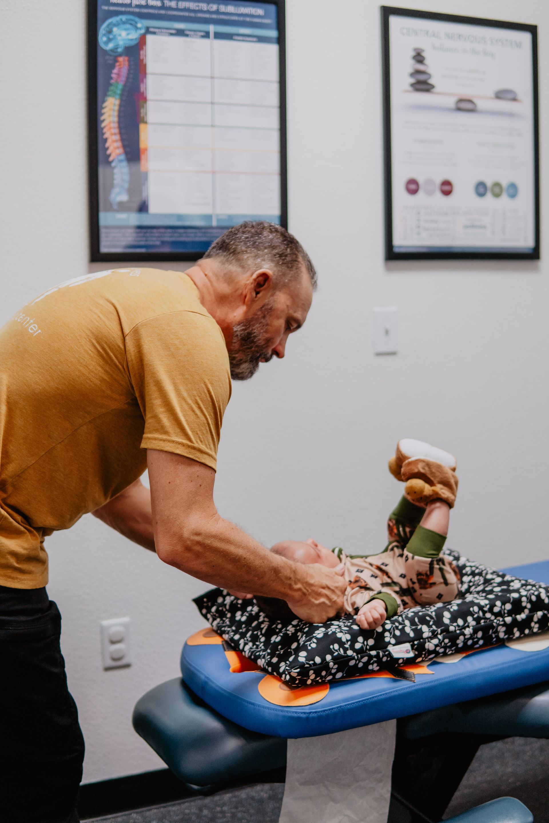 A woman in a blue shirt is getting a massage from a man.