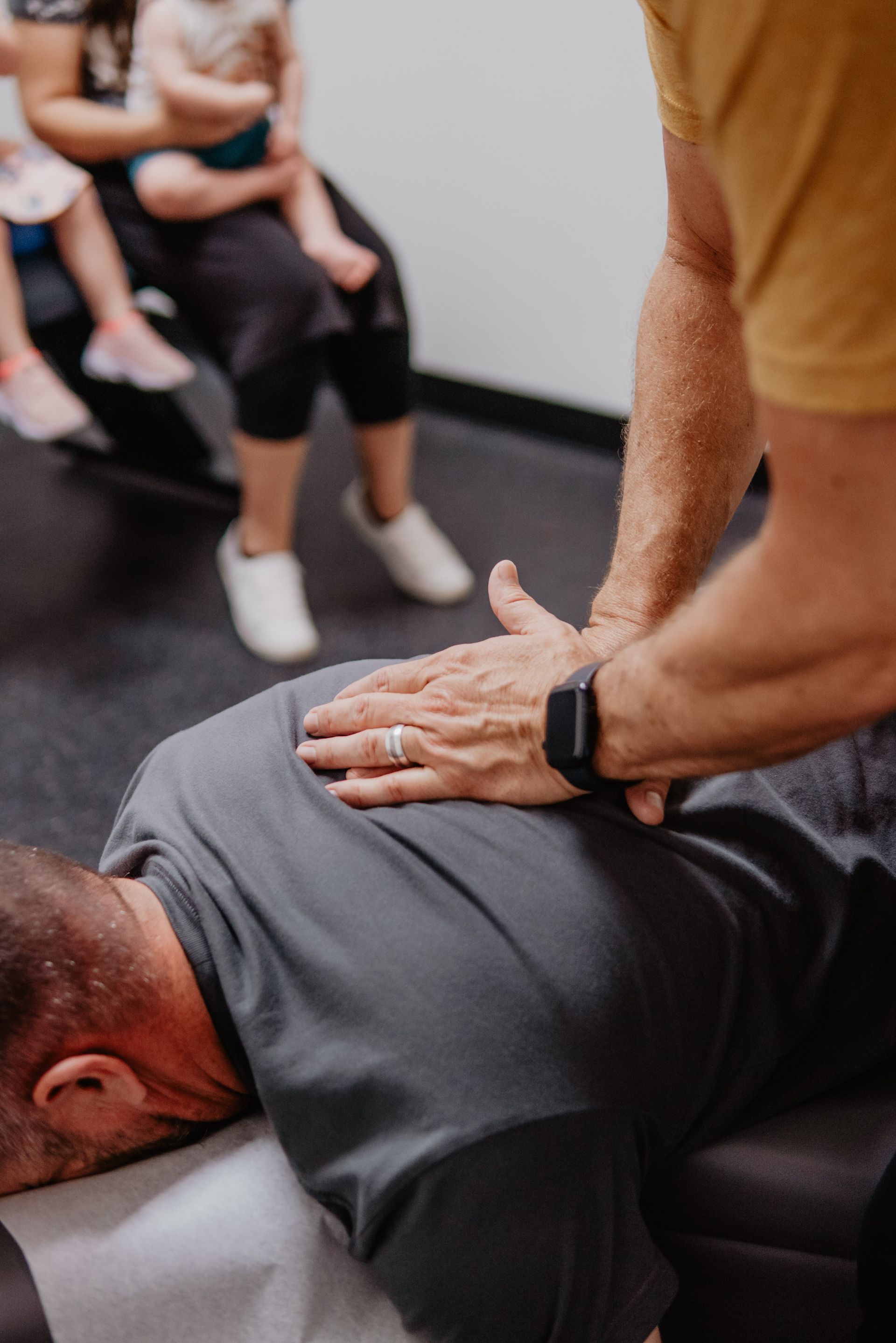 A person is giving a massage to another person 's back.