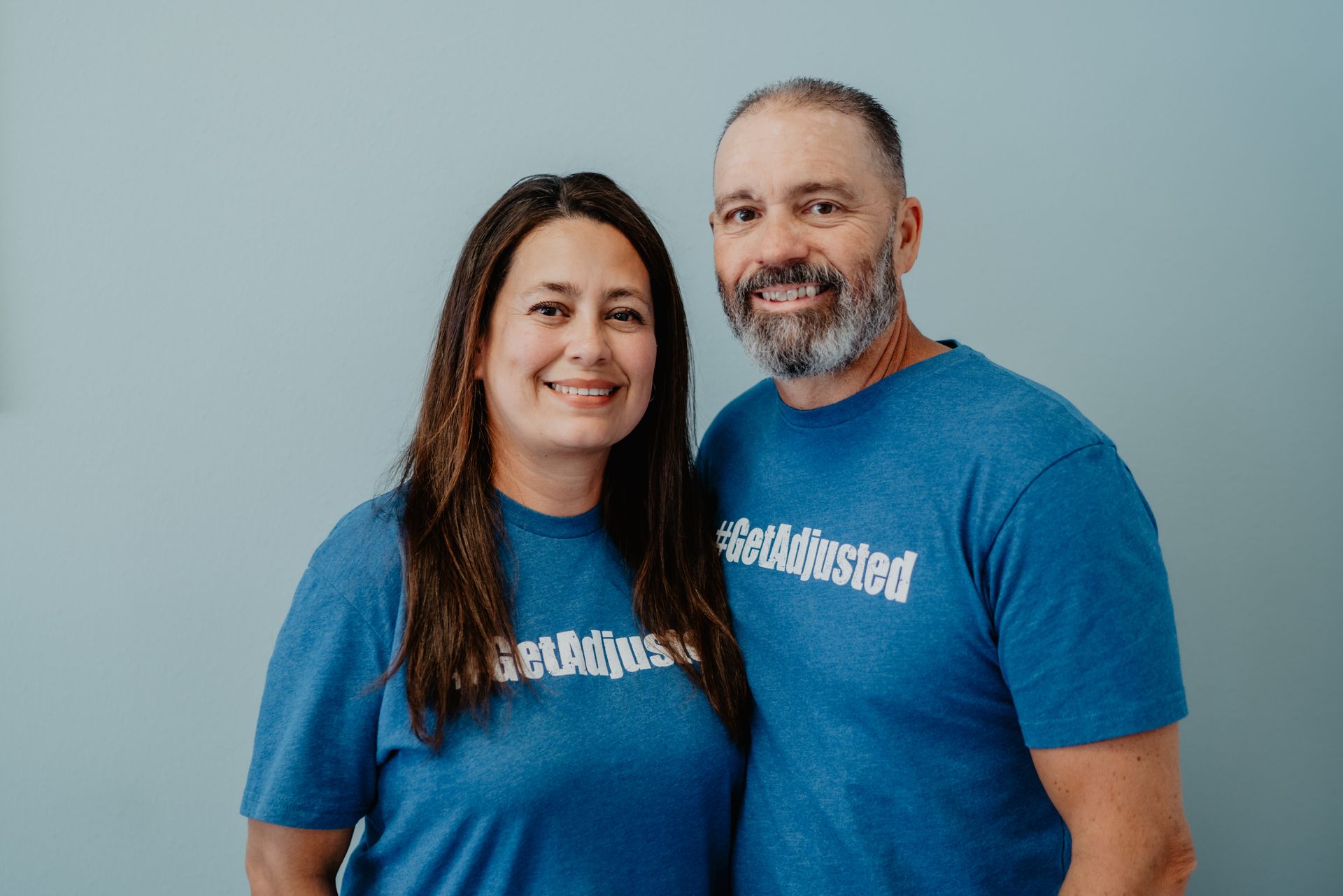 A group of people are posing for a picture in a room.