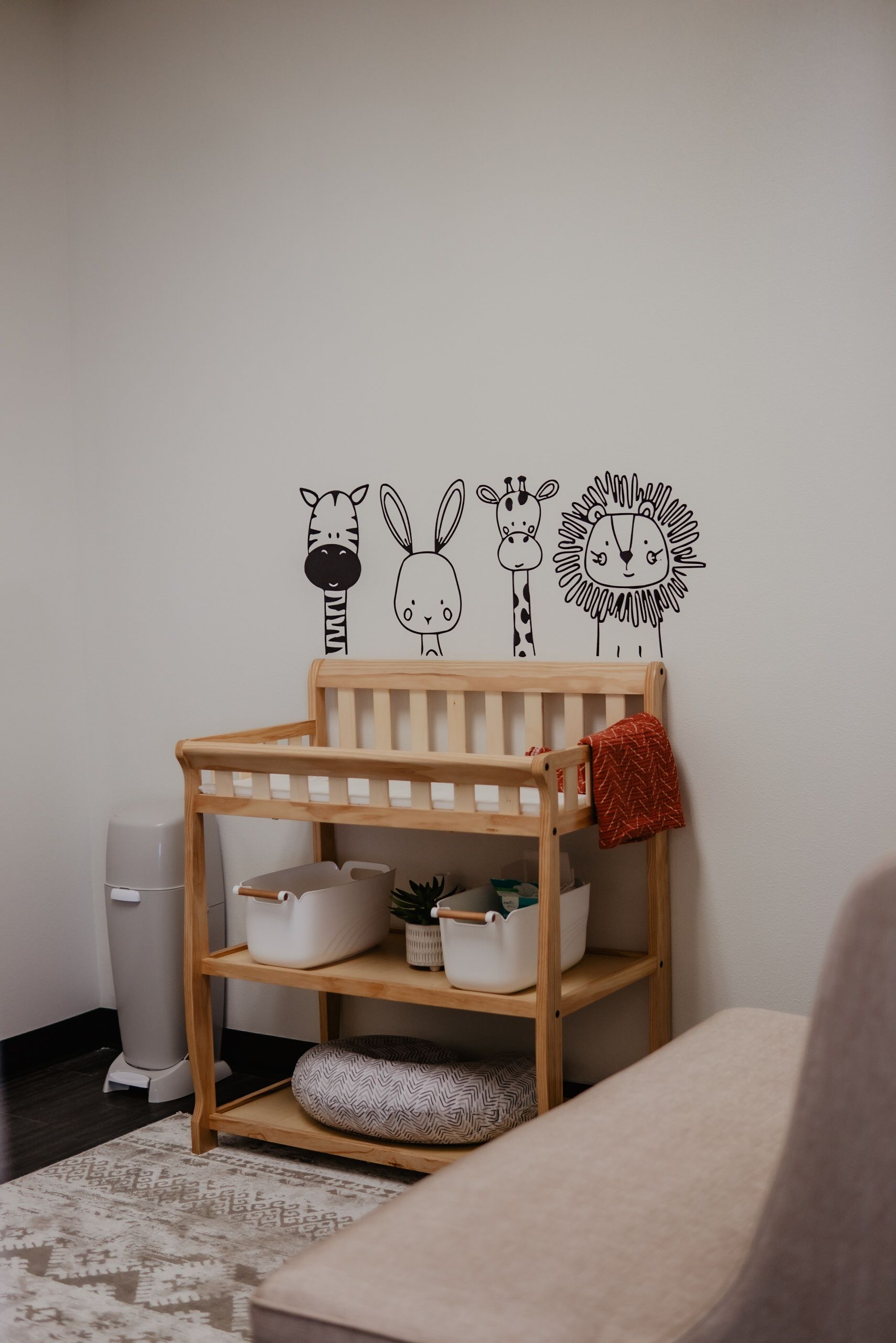 A room with a changing table and a couch.